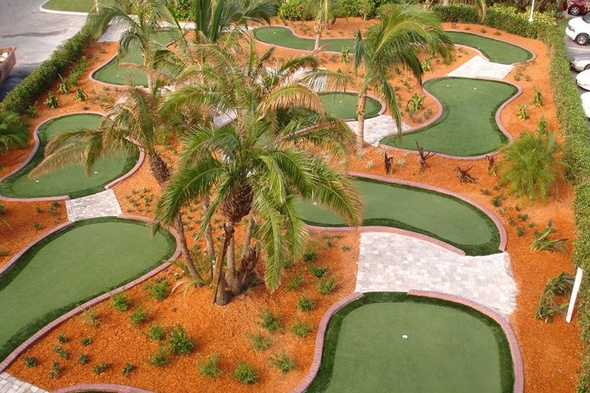 Fresno Aerial view of a mini golf course with synthetic grass and palm trees.